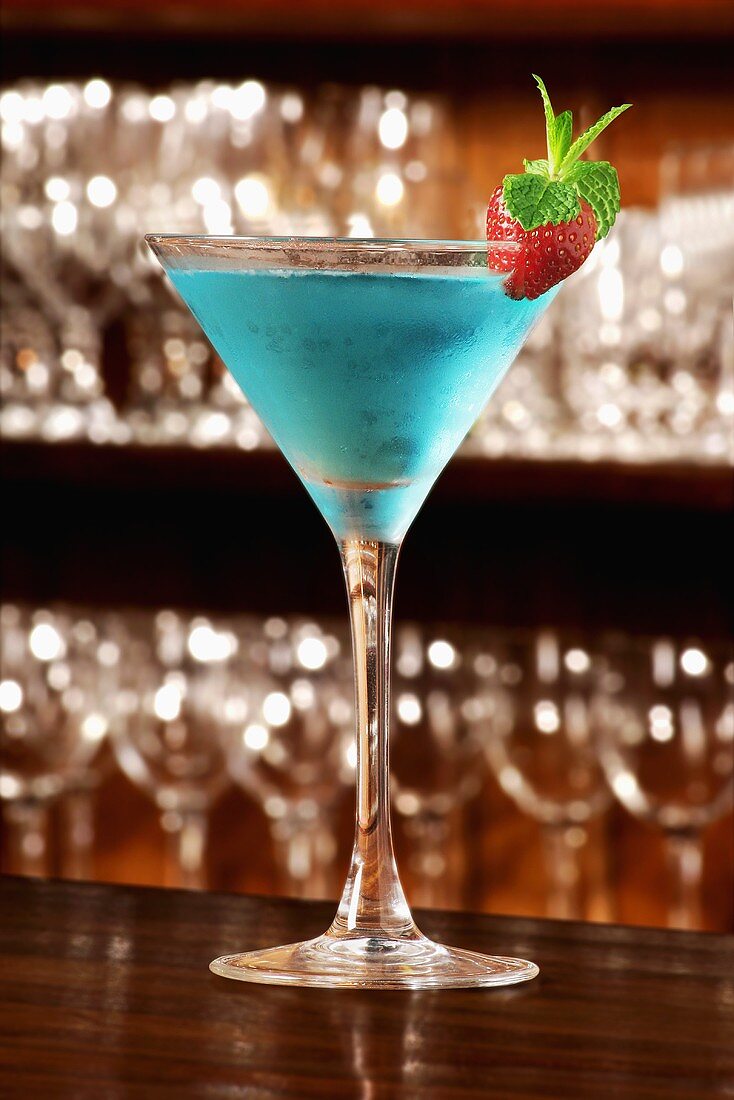 Blue Curacao cocktail with a strawberry on a counter