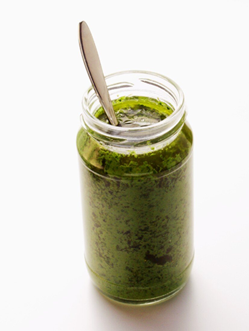 A Jar of Pesto with Spoon