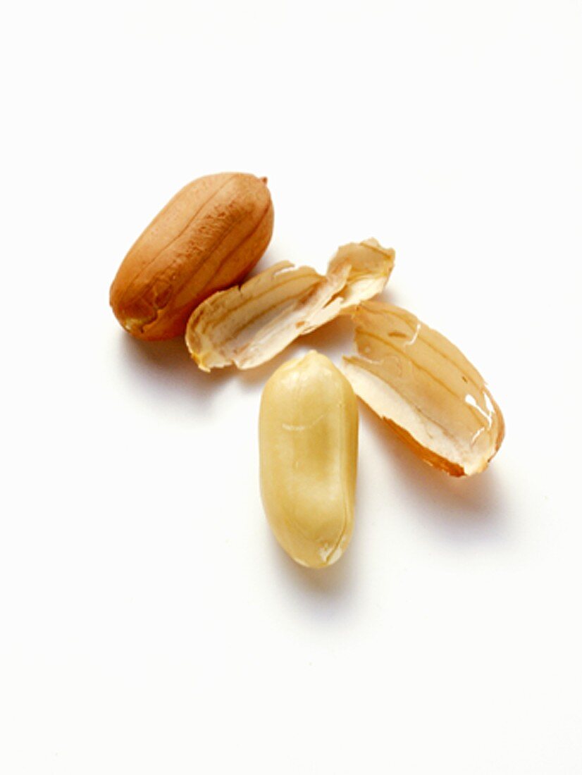 Two Shelled Peanuts, One with Skin Removed