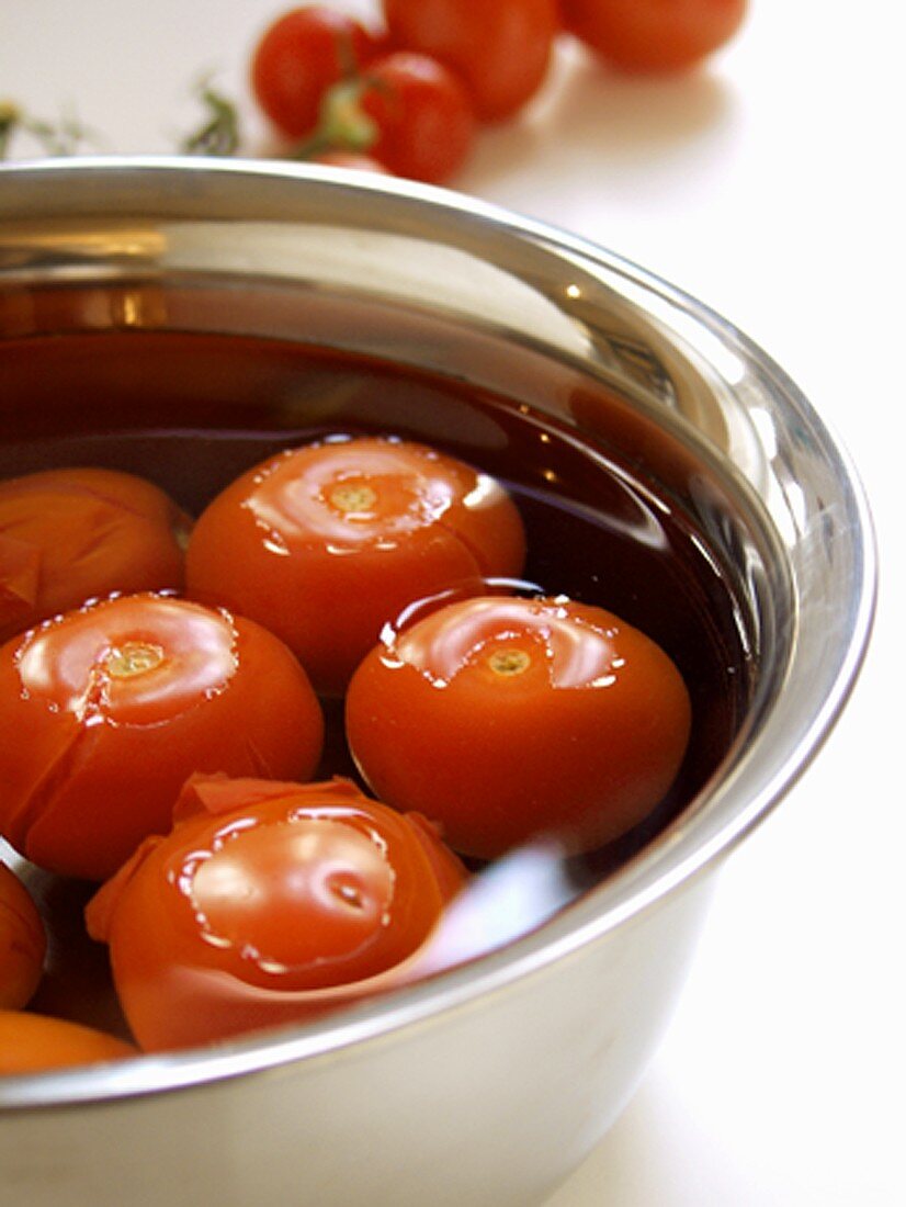 Whole Tomatoes in a Bowl of Water