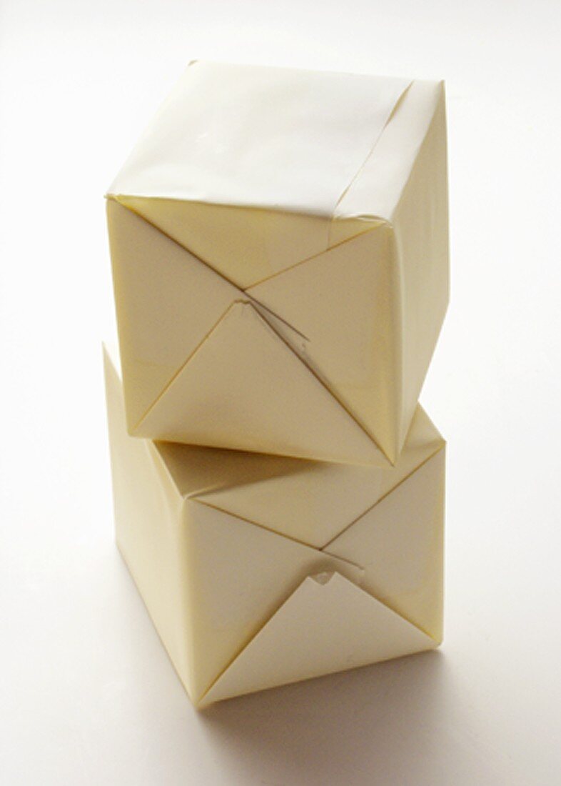 Two Cubes of Wrapped Butter
