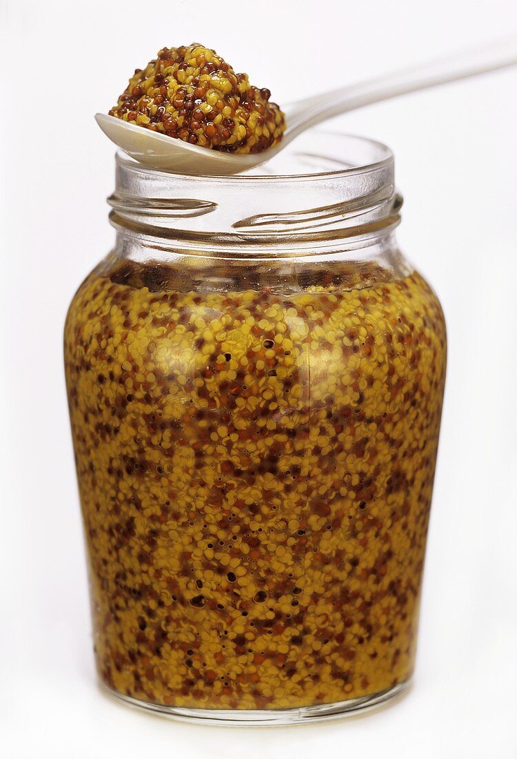A Jar of Dijon Mustard with Spoonful