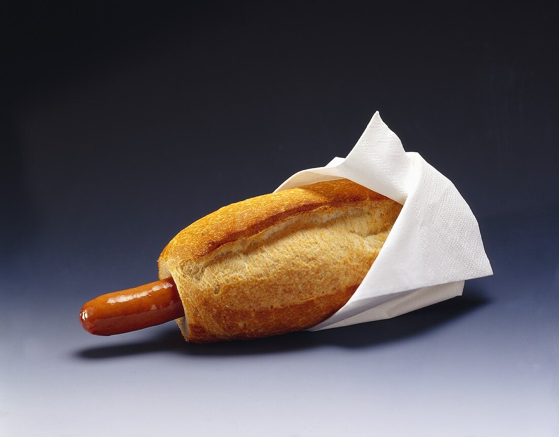 Hot dog with white napkin