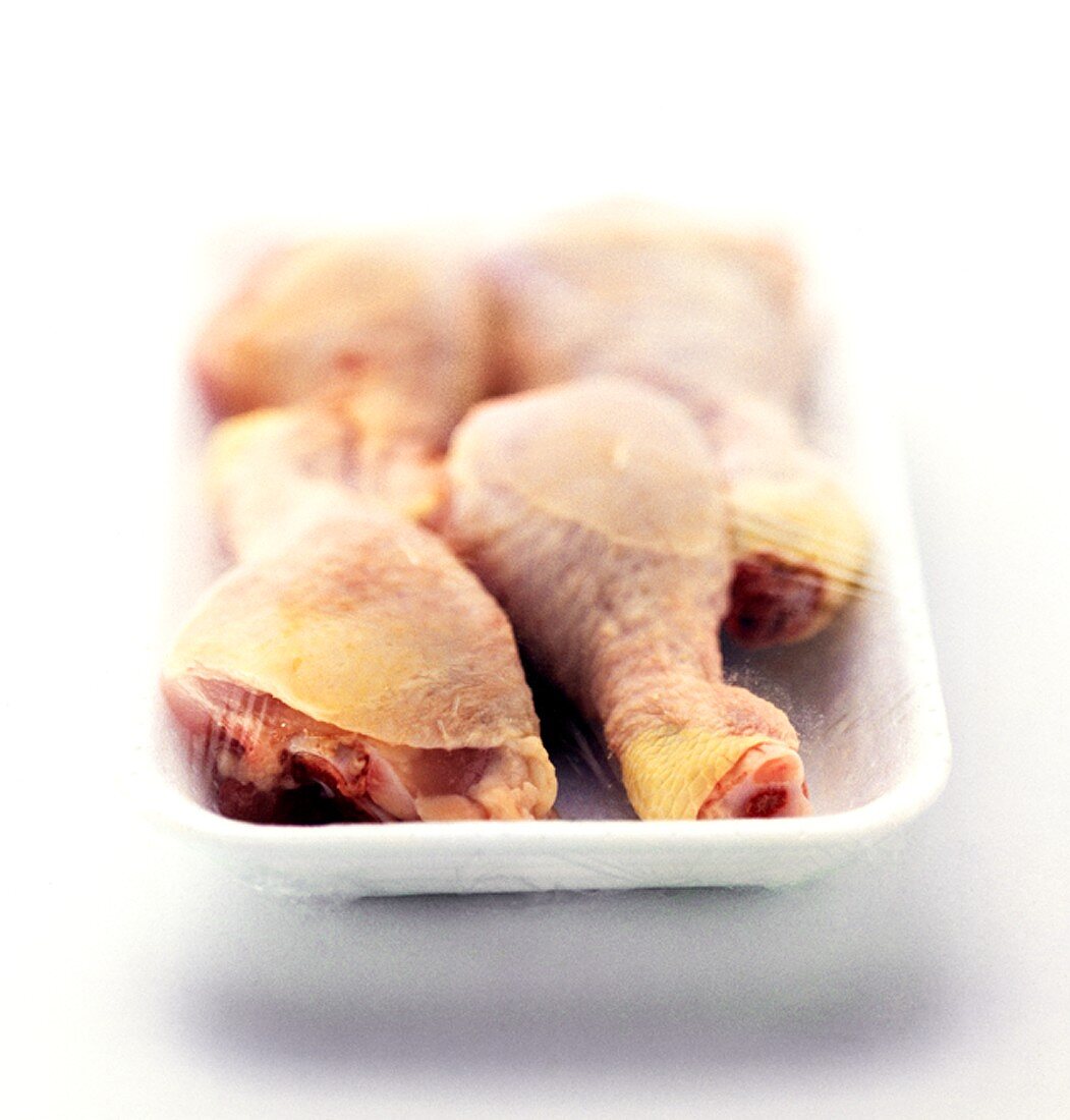 Chicken legs in food wrap