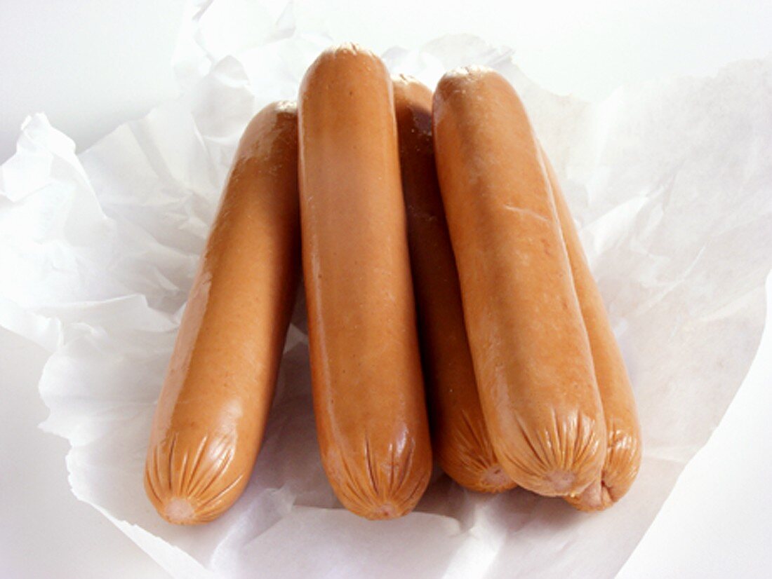 Uncooked Hot Dogs on Paper