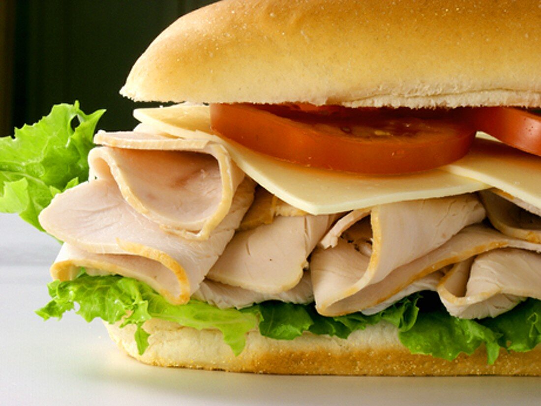 A Turkey Sub with Tomatoes, Cheese and Lettuce