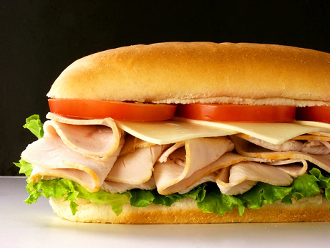 A Turkey Sub with Tomatoes, Cheese and Lettuce