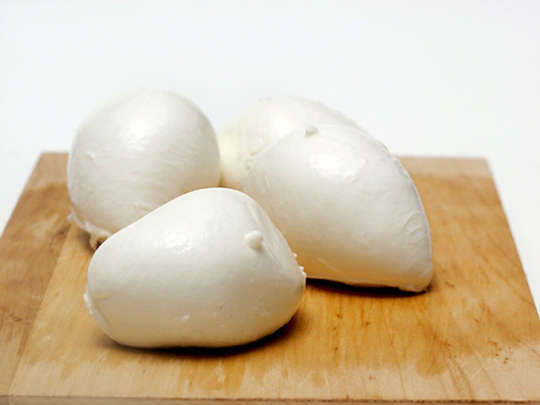 Several Balls of Fresh Mozzarella on Cutting Board