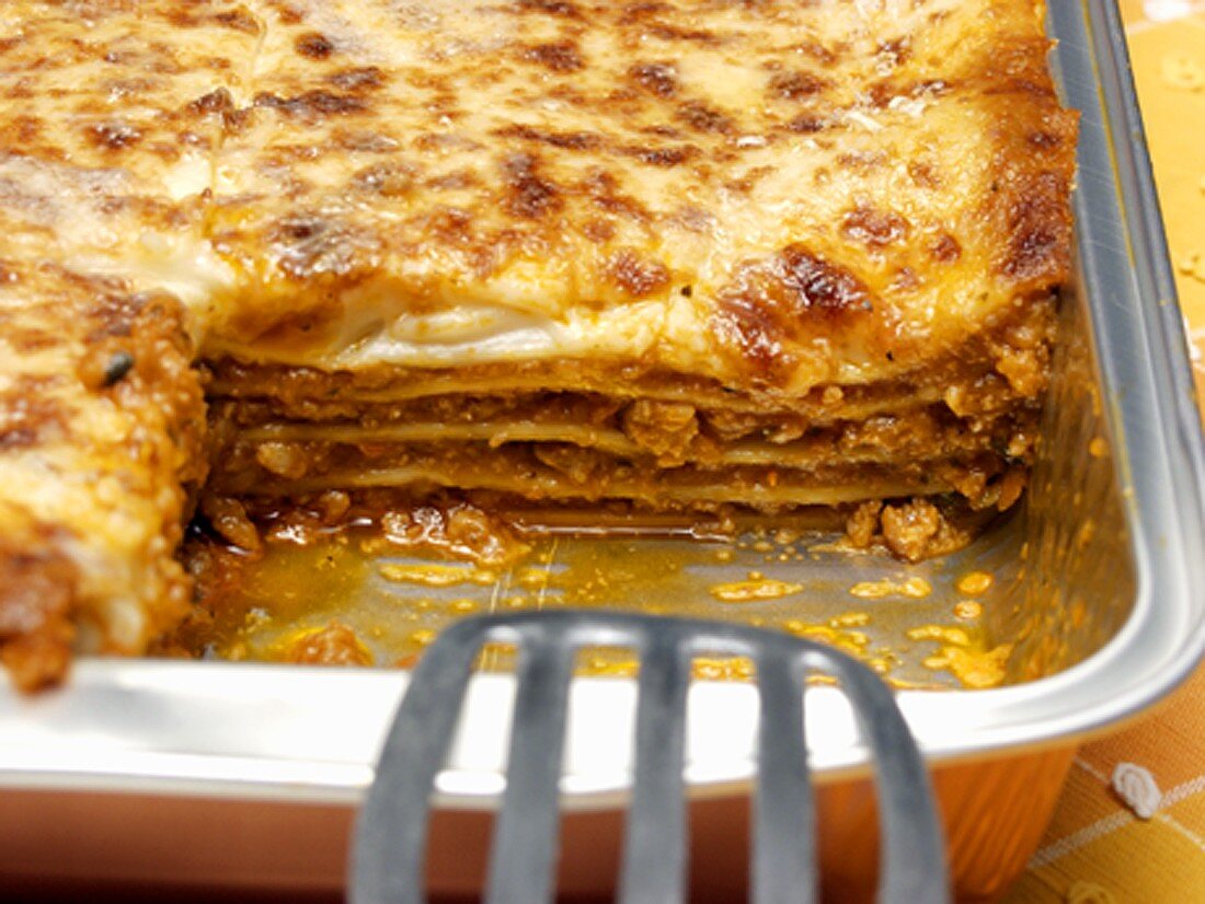 A Pan of Lasagna with Piece Taken Out