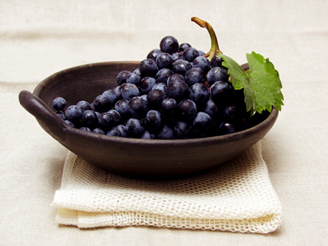 Purple Grapes in a Bowl Resting on a Towel