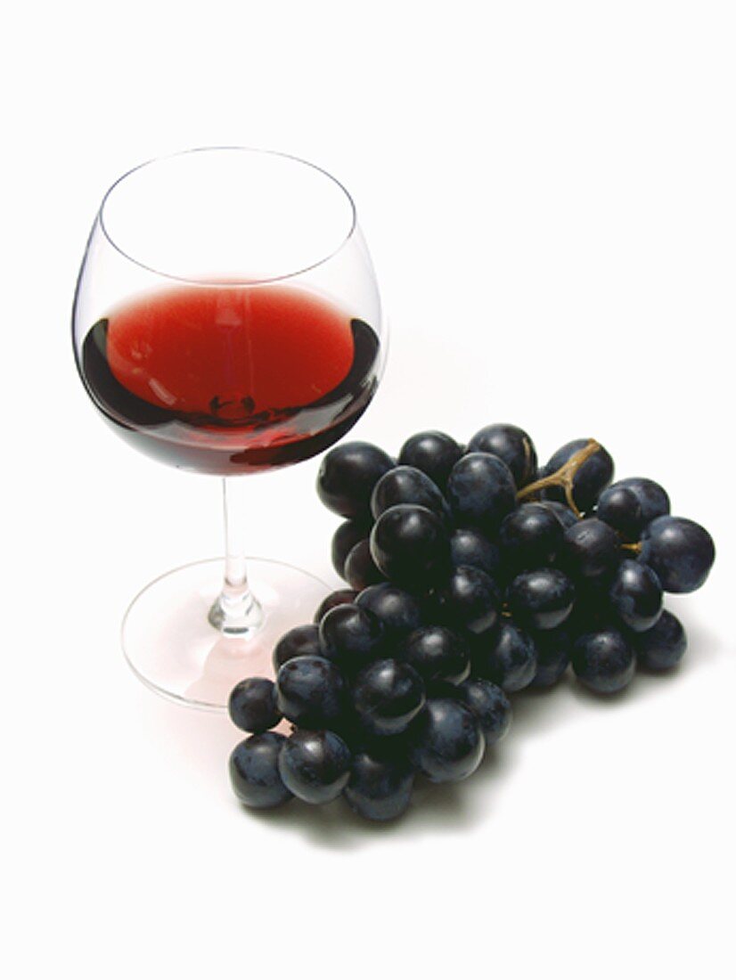 Glass of Red Wine with Purple Grapes