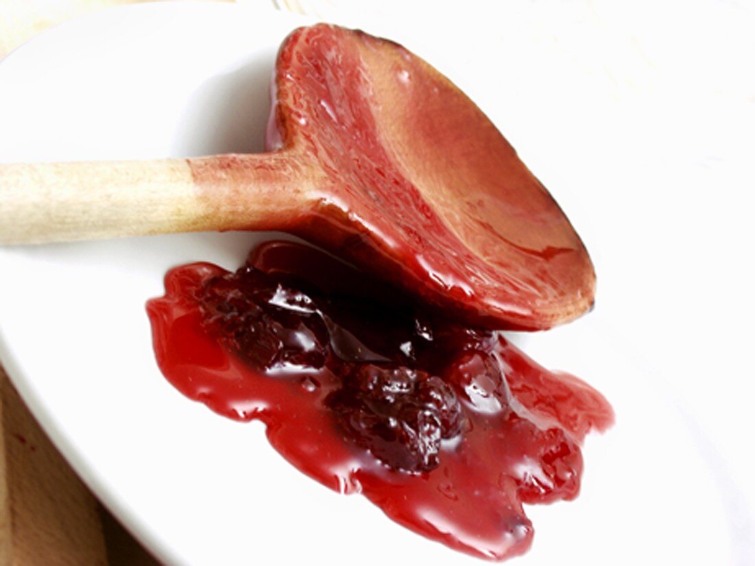 Cherry Sauce on Plate with Wooden Spoon