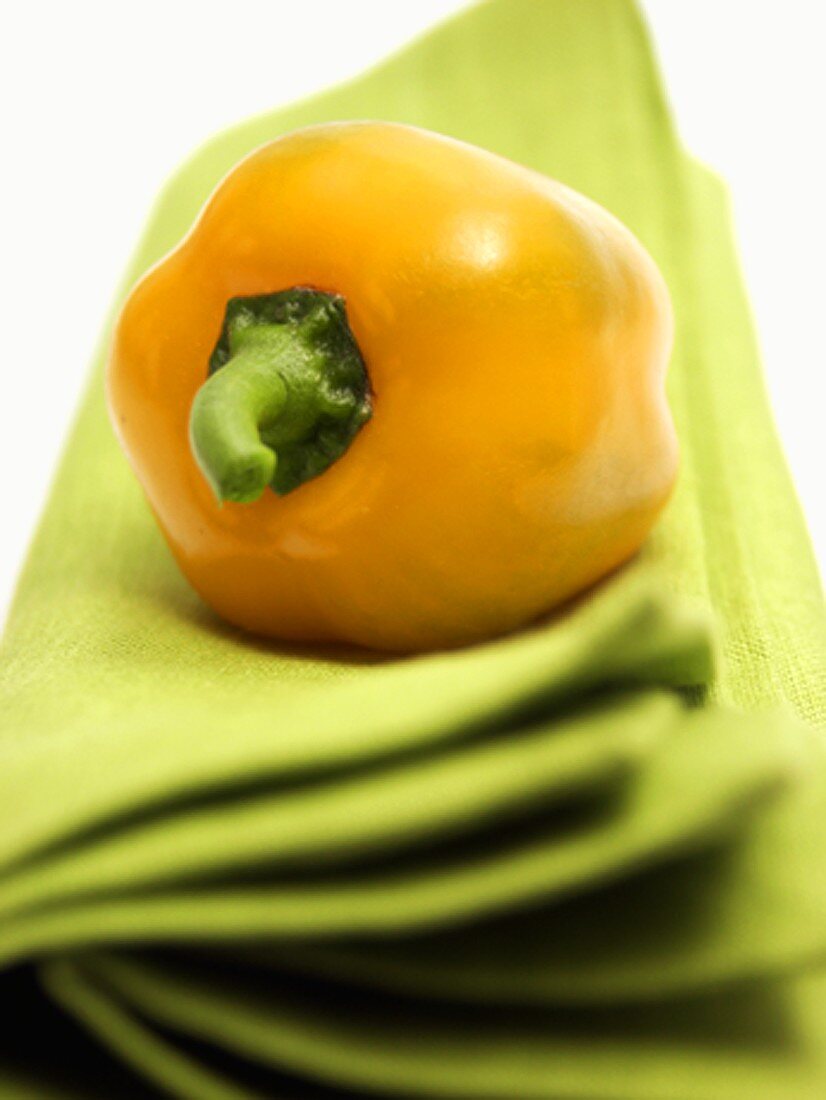 Yellow Bell Pepper Resting on a Green Cloth