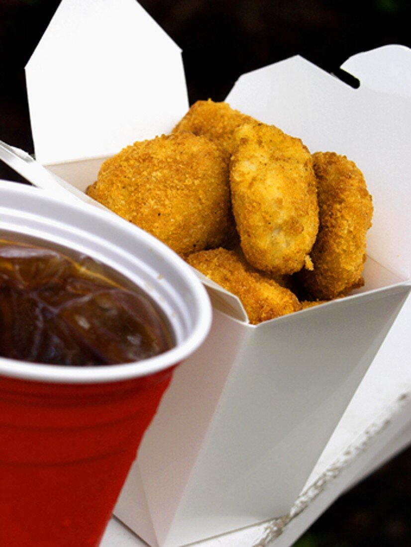 Chicken Nuggets in a Take-Out Box with a Cup of Cola