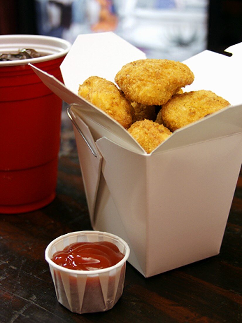Chicken Nuggets in a Take-Out Box with Ketchup and Soda