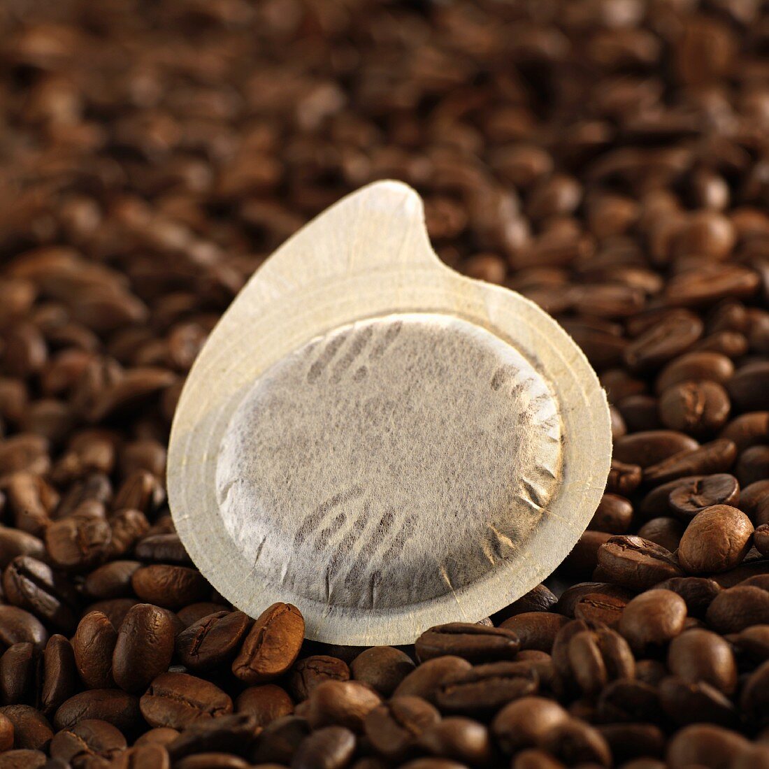 Espresso pod on coffee beans