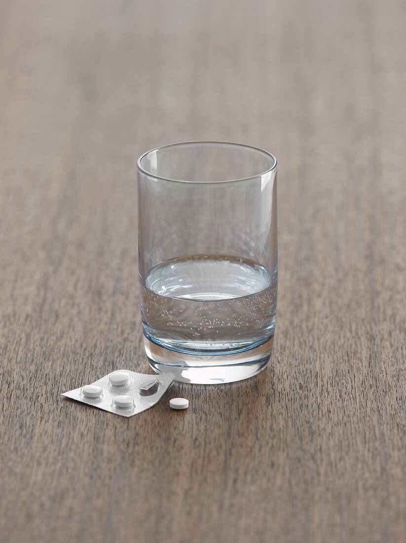 Glass of water with tablets