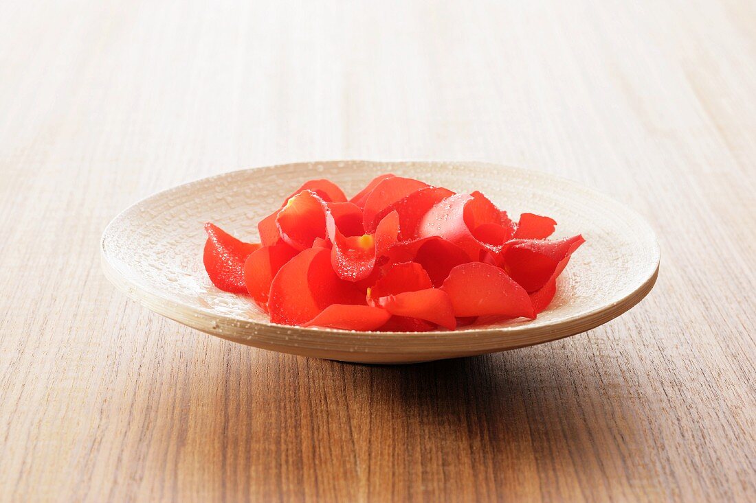 Red rose petals in a dish
