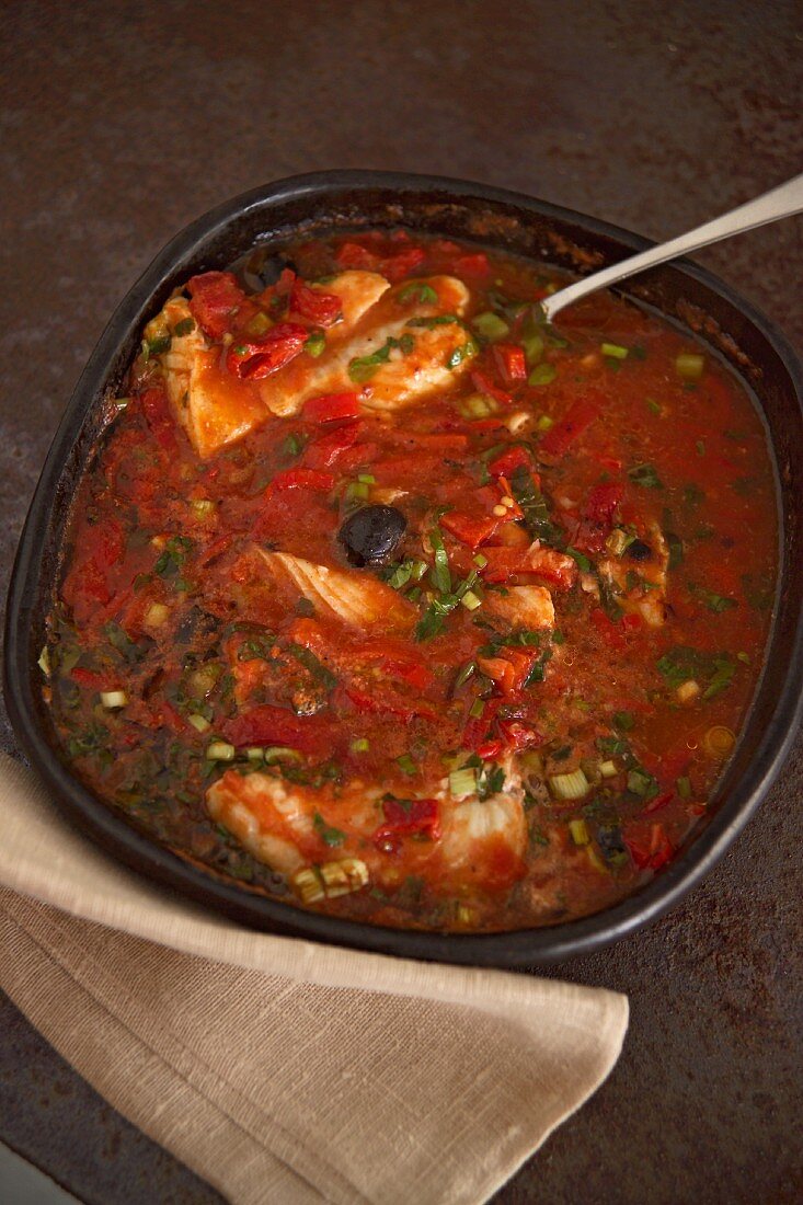 Cod with olives and spring onions in pepper sauce