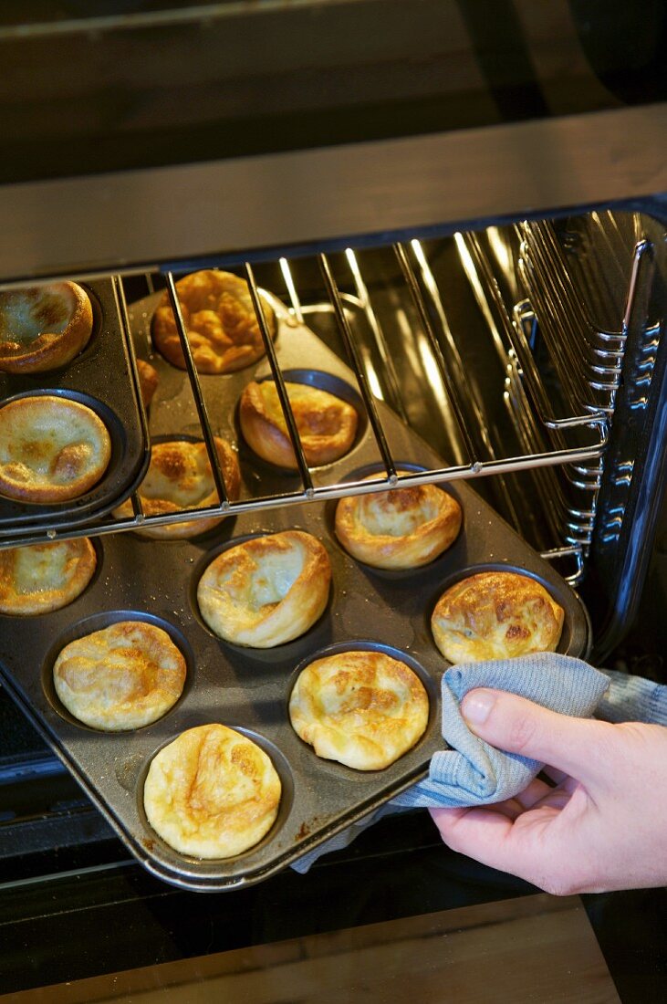 Taking Yorkshire puddings out of the oven