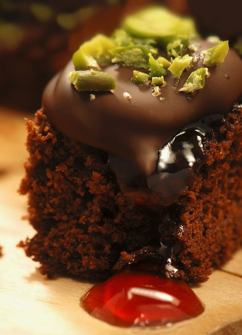 Brownies with redcurrant jelly, chocolate coating & pistachios