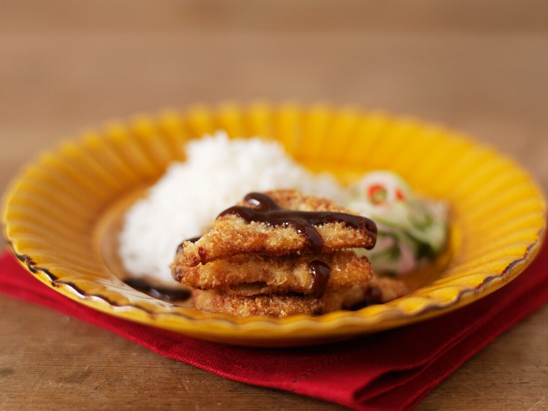 Fish cakes with soy sauce, rice and cucumber relish