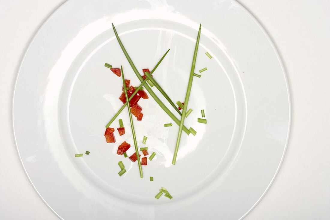 Chives and diced red pepper on plate