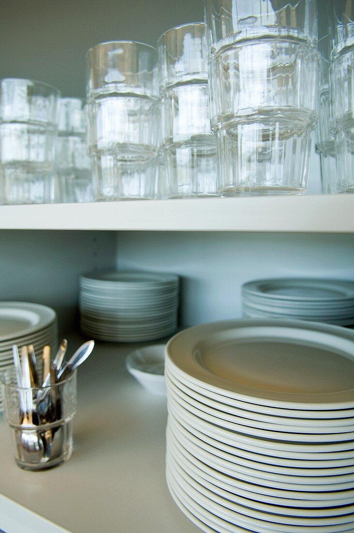 Plates and glasses on kitchen shelves