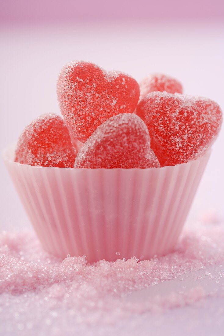 Sugar-coated, red, heart-shaped jelly sweets (close-up)