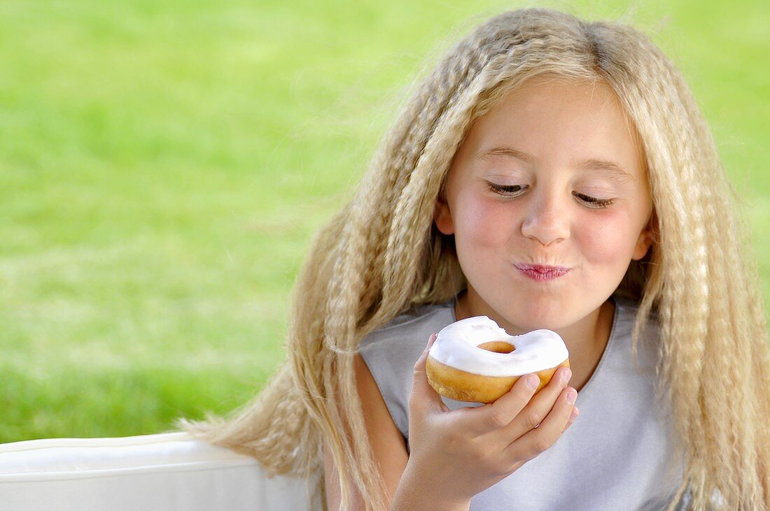 Blond girl eating doughnut