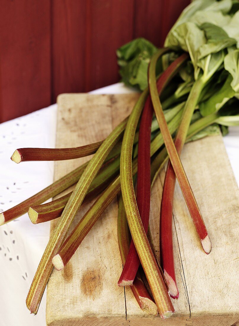 Sticks of rhubarb on wooden board