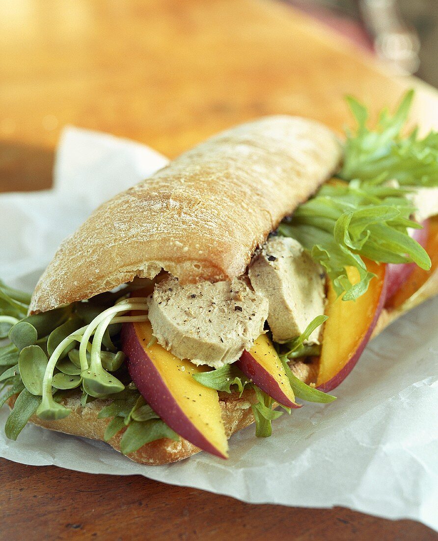 Ciabatta filled with salad, chicken breast and nectarines