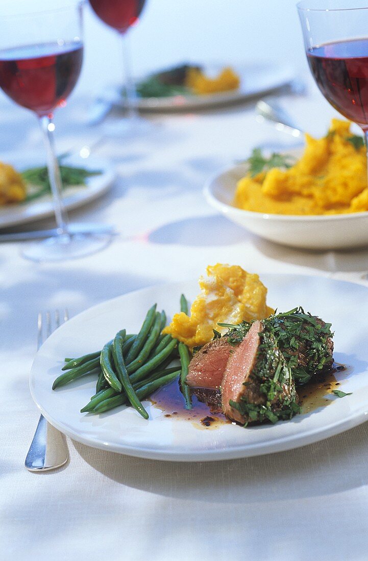 Roast lamb with herbs, French beans and pumpkin puree