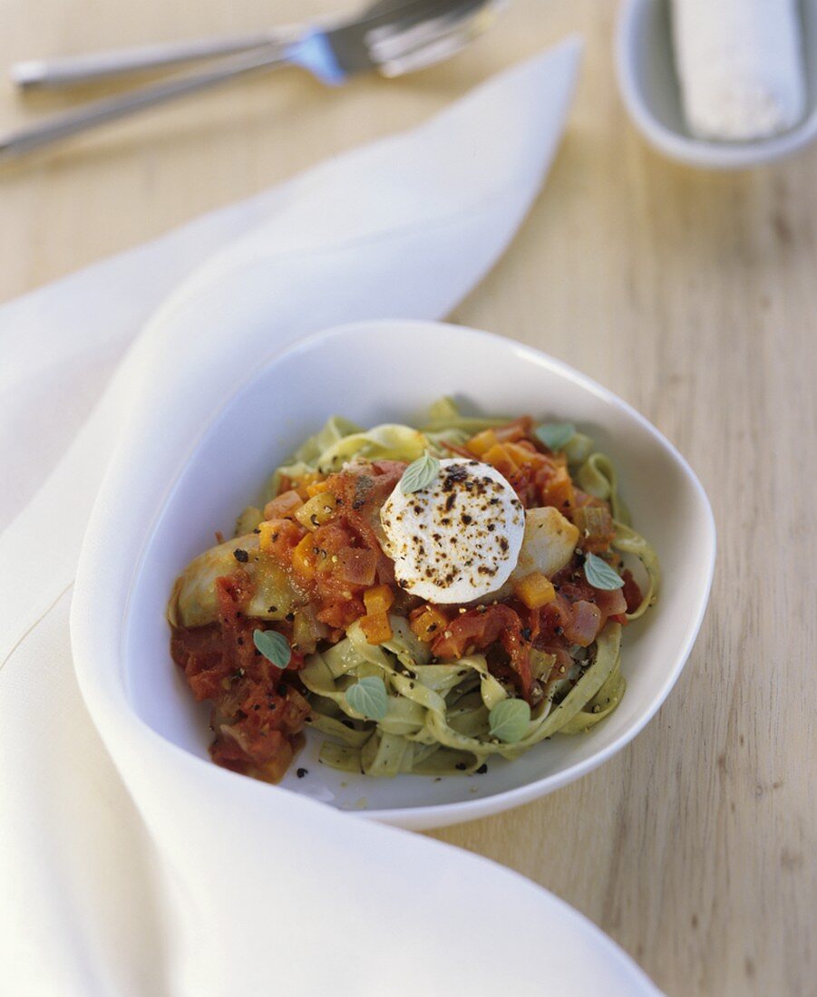 Green ribbon pasta with tomato sauce and goat's cheese