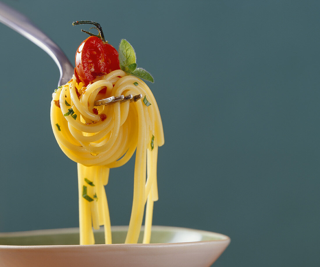 Spaghetti with tomato on fork