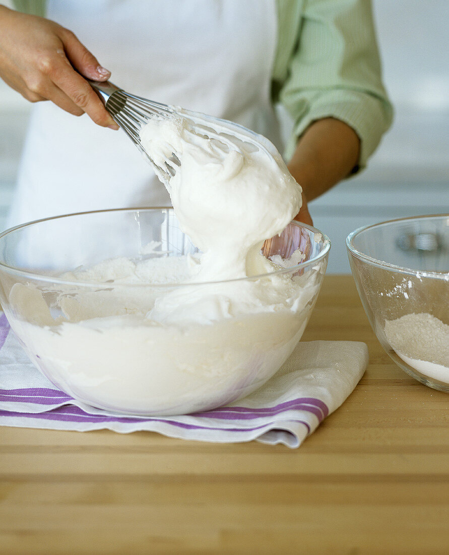 Beating egg white stiffly with a whisk