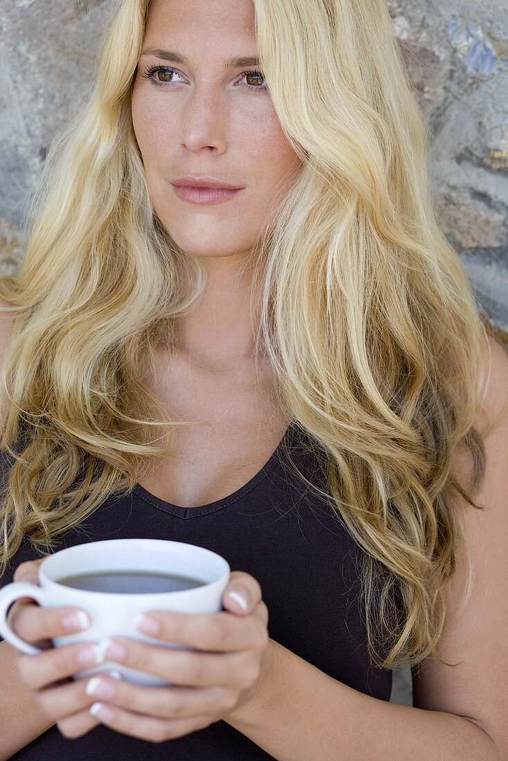 Blond woman holding a cup of tea