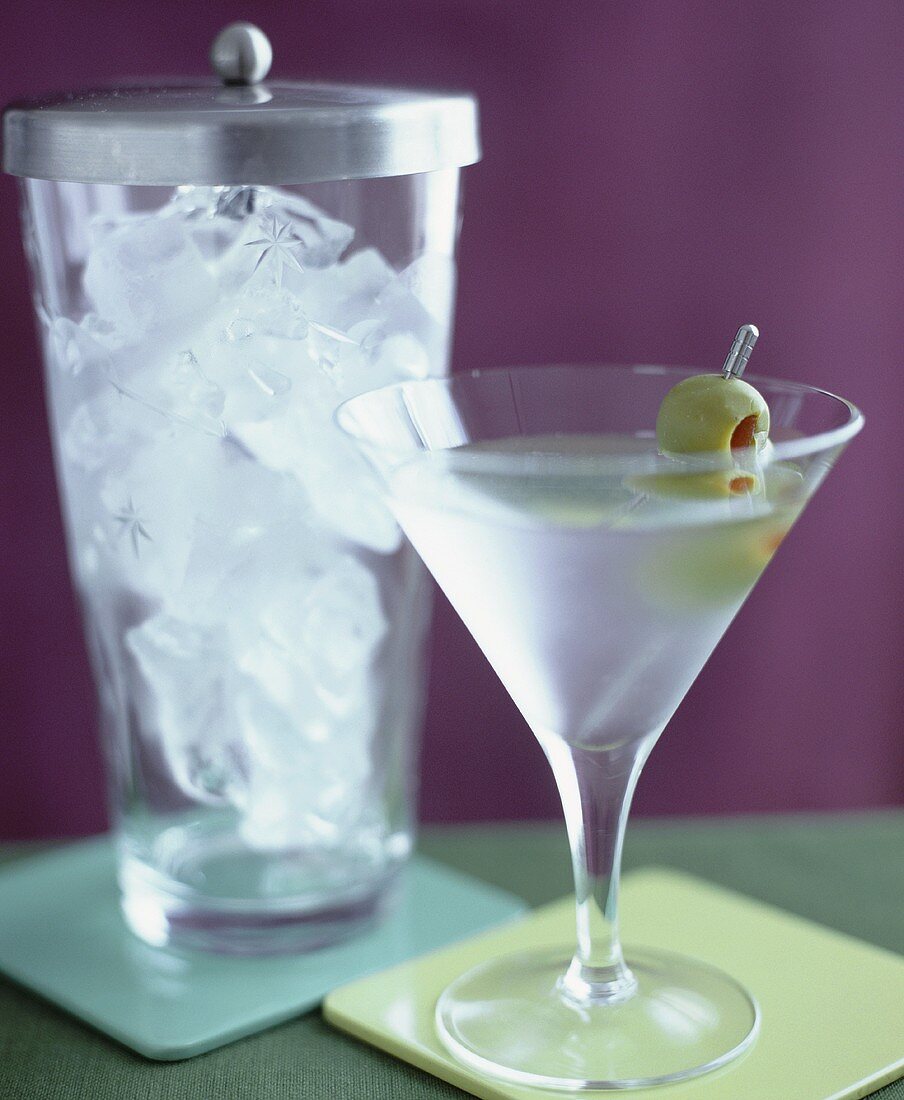 Martini with olive and a jar of ice cubes