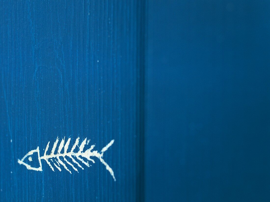 Fischgräte auf blauen Holzuntergrund gemahlt