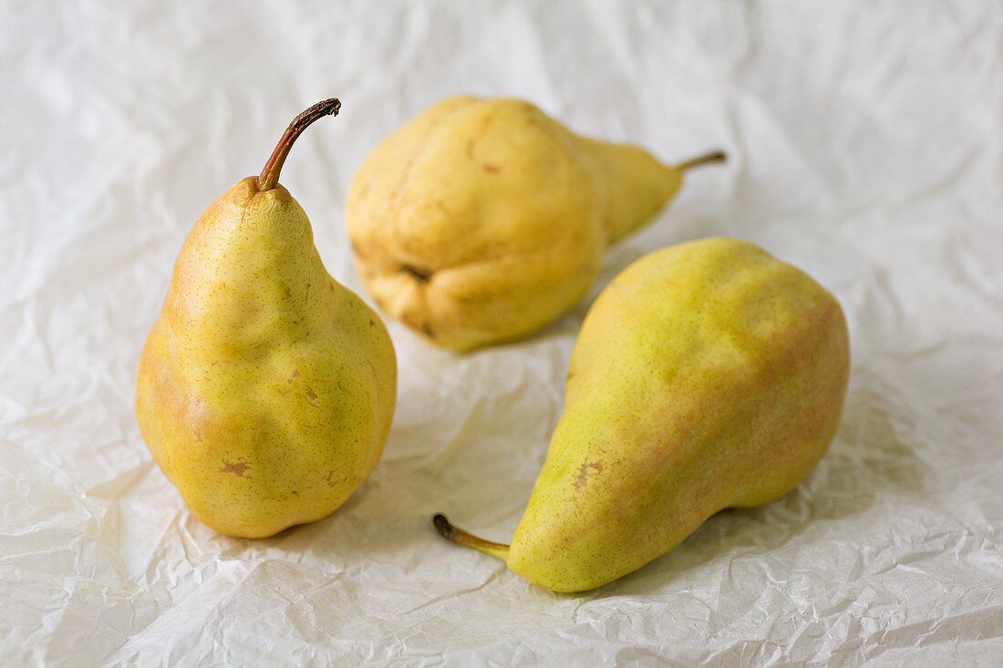 Three pears on greaseproof paper