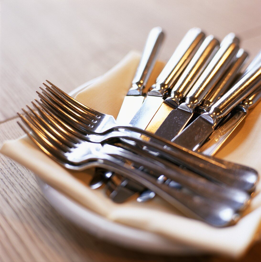 Knives and forks on a plate with fabric napkin