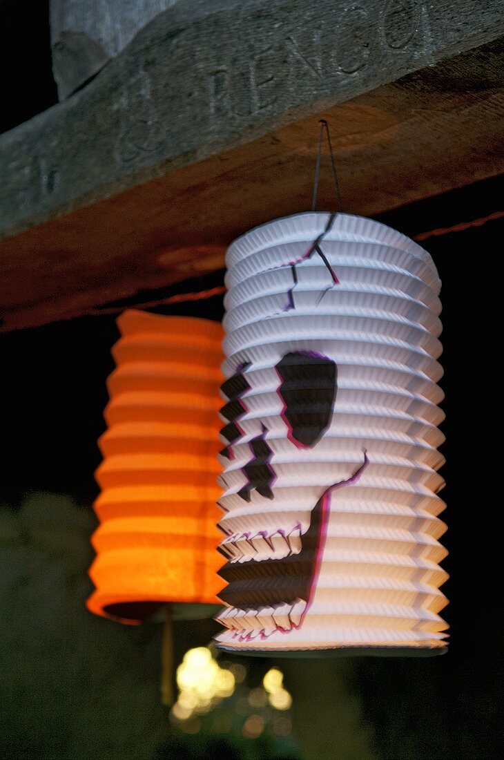 Two lanterns hanging up for Halloween
