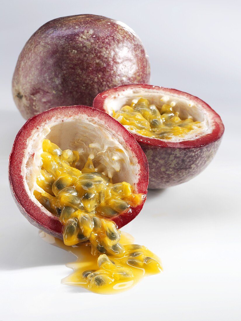 Whole and halved passion fruit