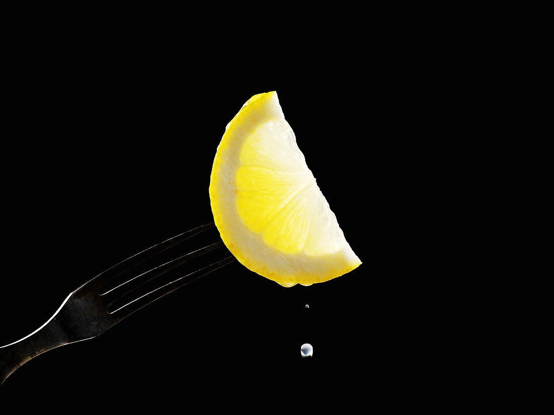 Half a slice of lemon on a fork