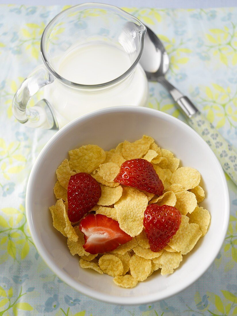 Cornflakes with milk and strawberry for breakfast