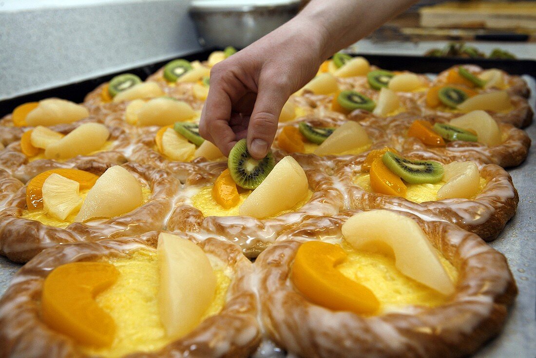 Putting fruit on Danish pastries