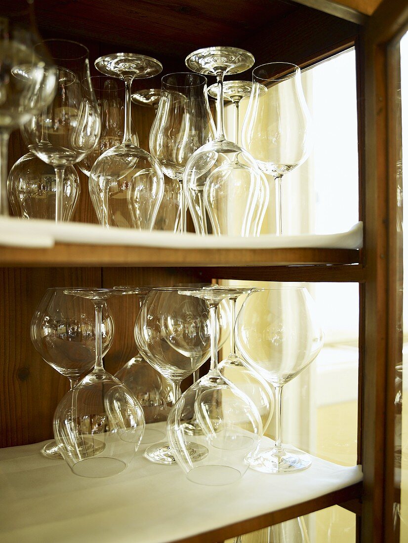 An assortment of wine glasses in a cabinet