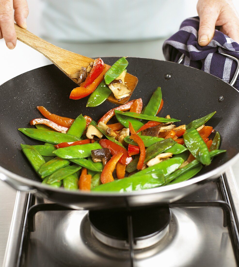 Sautéing vegetables in a wok