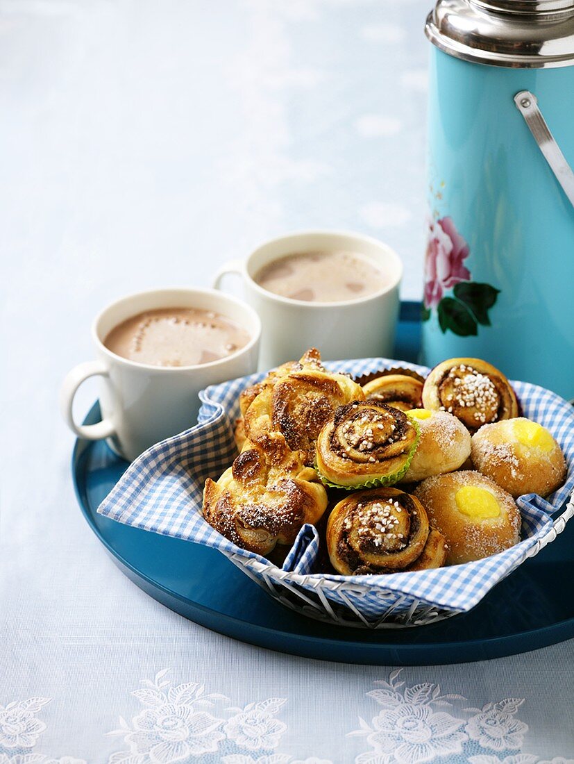 Basket of pastries and cocoa on tray