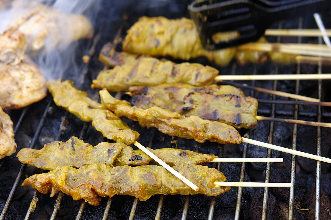 Chicken satay on a barbecue